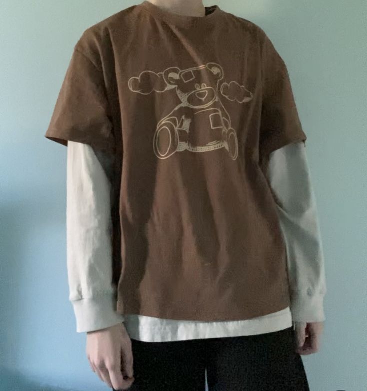 Teddy bear warm brown shirt over a cream long sleave under shirt. Black baggy pants. Shirt And Long Sleeve Layer, Grunge Brown Outfit, Black Shirt Under T Shirt Outfit, Brown Baggy Shirt Outfit, Baggy Long Sleeve Shirt Outfit Men, Sleeves Under Shirt Outfit, Baggy Shirt With Long Sleeve Under, Brown Baggy Outfit, Layered Shirts Outfit Men