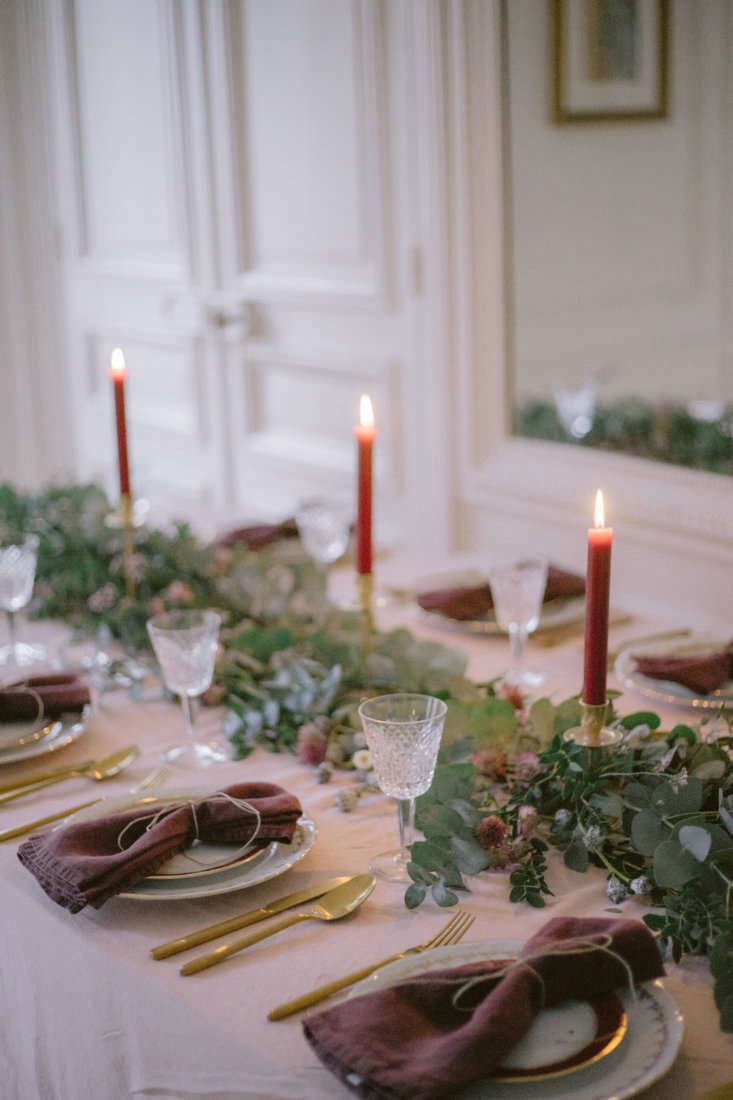 a table set with place settings and candles