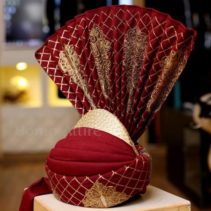 a red and gold fan sitting on top of a table