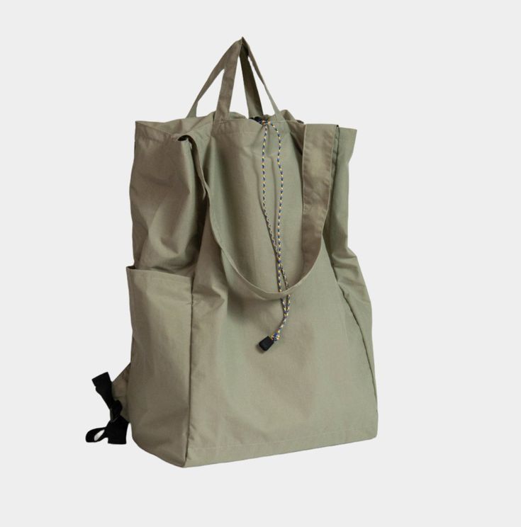 A versatile, lightweight, water-repellent bag that can be worn as a backpack, shoulder bag, or carried by hand. Sporty Bags With Adjustable Straps For Daily Use, Sporty Everyday Shoulder Bag With Adjustable Straps, Rectangular Nylon Bag With Adjustable Straps, Functional Backpack With Adjustable Straps For Daily Use, Versatile Khaki Nylon Bag, Nylon Travel Backpack With Removable Pouch, Outdoor Tote Bag With Adjustable Strap, Nylon Travel Bag With Removable Pouch For Outdoor, Practical Outdoor Bags With Adjustable Straps