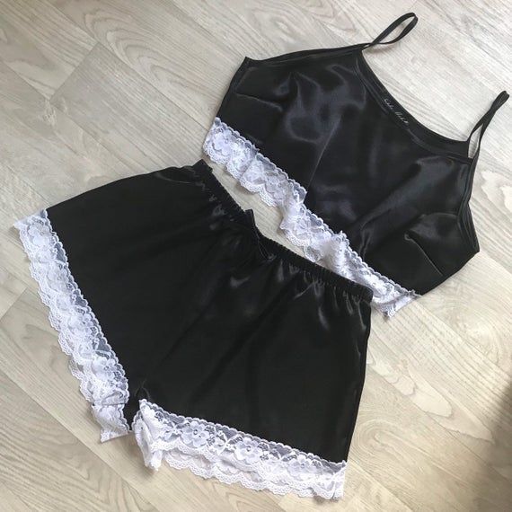 Black satin pyjamas with white lace trim Satin Sets With Lace Trim For Wedding Night, Satin Lace Trim Sets For Wedding Night, Fitted Lace Trim Sets For Pajama Party, Summer Night Satin Sets, White Satin Sets For Summer, Sleepwear Sets With Lace Trim, Lace Sleepwear Sets With Lace Trim, Lace Sleep Sets With Lace Trim, Summer Lace Sleep Sets