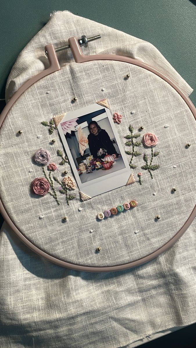 an embroidered photo frame with flowers on it