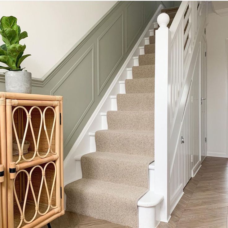 a wooden cabinet sitting next to a stair case