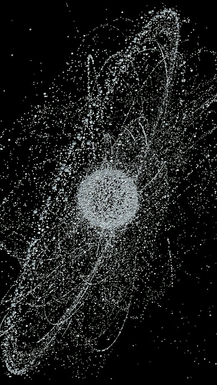 a black and white photo of an object in the air with water splashing around it