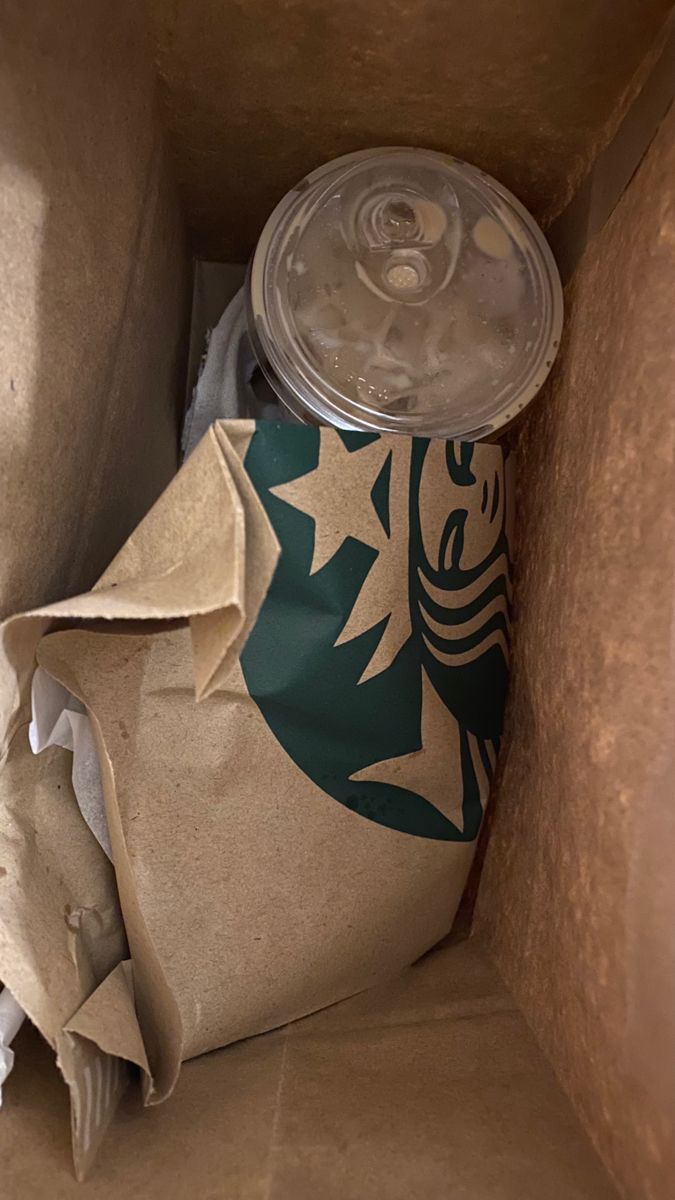 a starbucks coffee can in a cardboard box