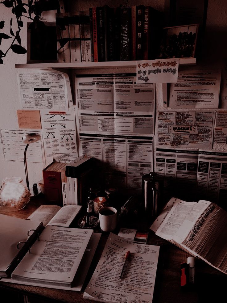 an office desk with many papers on it