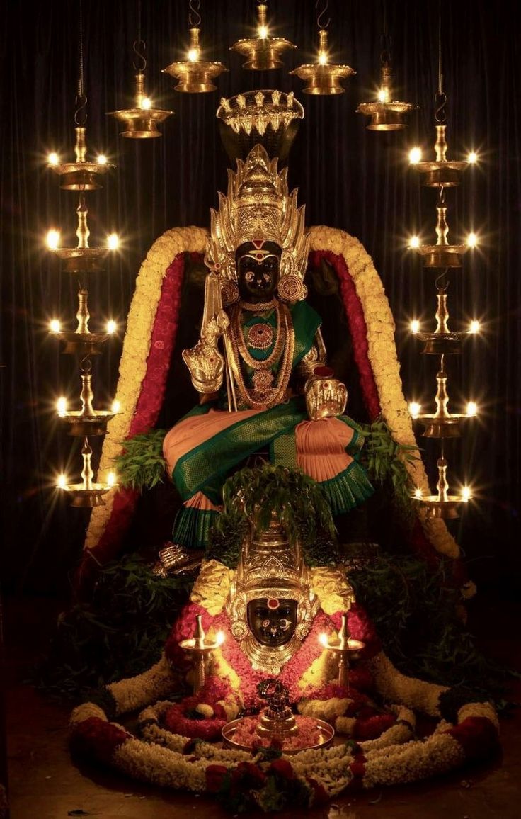 the statue is decorated with lights and garlands