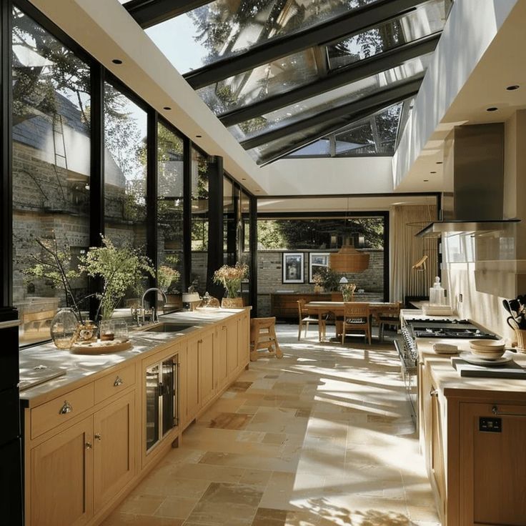 an open kitchen with lots of counter space and skylights in the ceiling, along with large windows