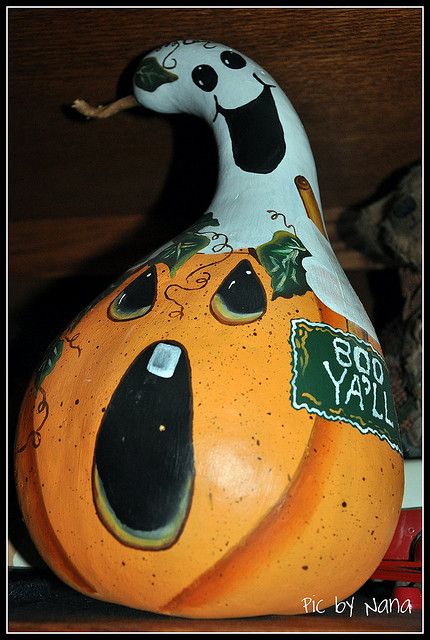 a pumpkin shaped like a bird with a tag on it's head and eyes