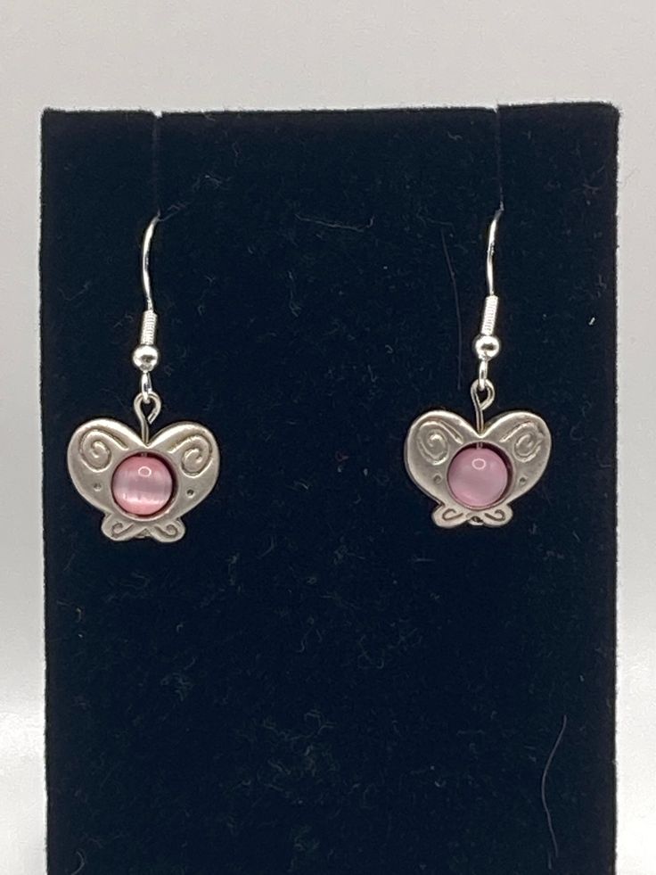 Pink butterfly earrings with a Sterling silver hook. Butterfly Earrings With Ear Wire For Gifts, Butterfly Earrings With Ear Wire As Gift, Silver Earrings With Butterfly Charm For Gift, Butterfly Shaped Earrings With Ear Wire For Gifts, Silver Butterfly Earrings For Gift, Elegant Adjustable Earrings With Butterfly Charm, Silver Butterfly Jewelry With Matching Earrings, Silver Butterfly Earrings With Ear Wire, Silver Fairycore Drop Earrings