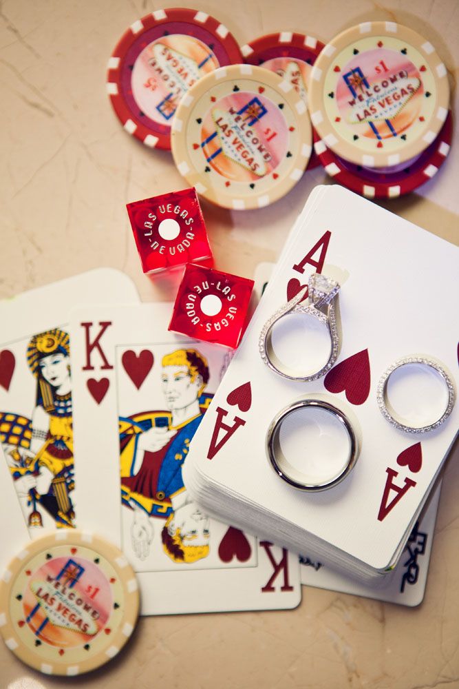 playing cards, rings and tokens on a table