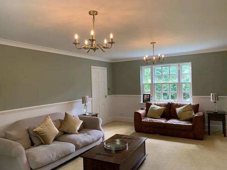 a living room filled with furniture and a chandelier