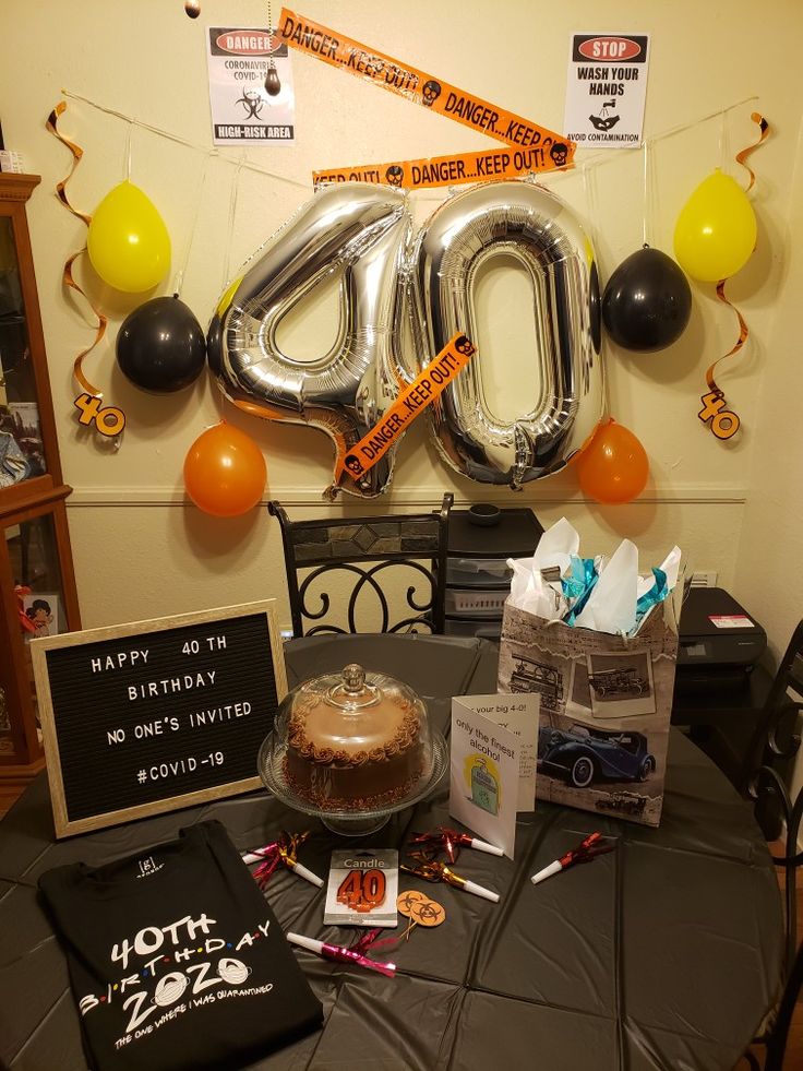 the table is set up with balloons and decorations for an 80th birthday party or celebration