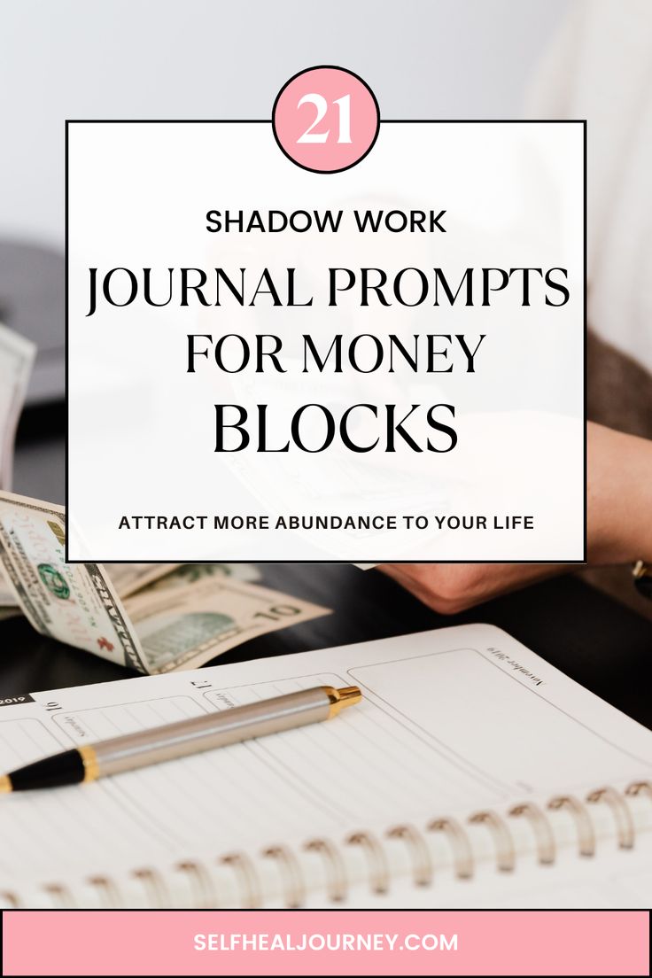 a woman's hand with money and pen in front of her on top of a desk