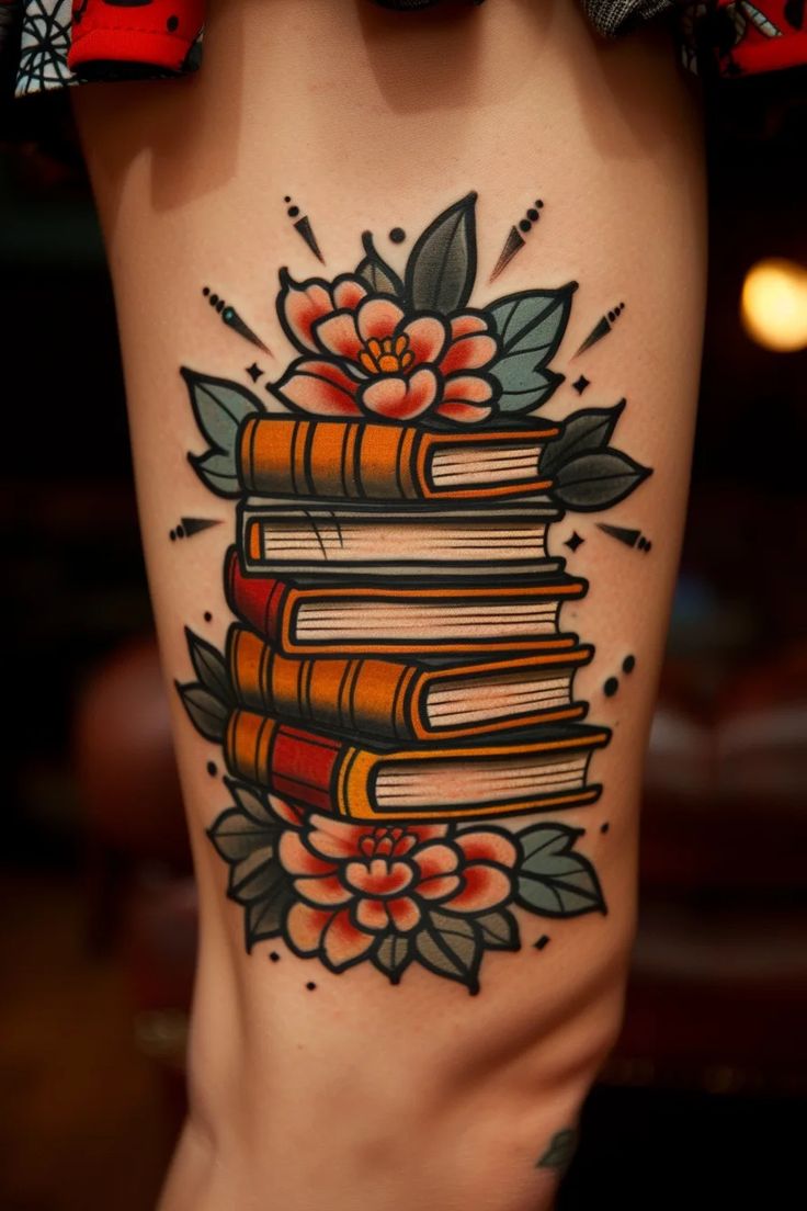 a woman's leg with books and flowers on it