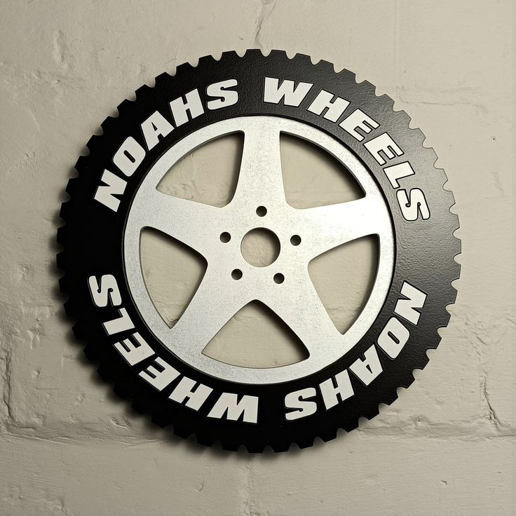 a black and silver sign that says wahs wheels, sleepman's showroom