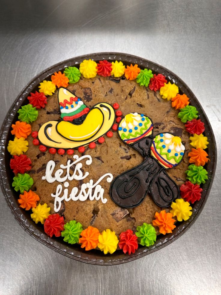 there is a cake that says let's fiesta on it and some decorations in the middle