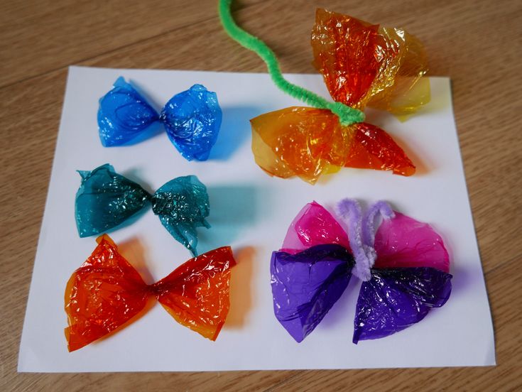 four candy bows are sitting on a piece of paper