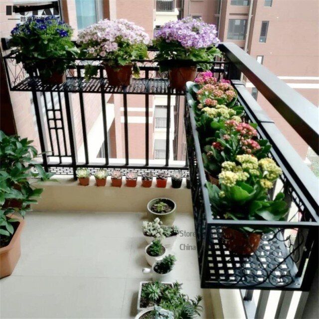 the balcony is filled with potted plants and flowers