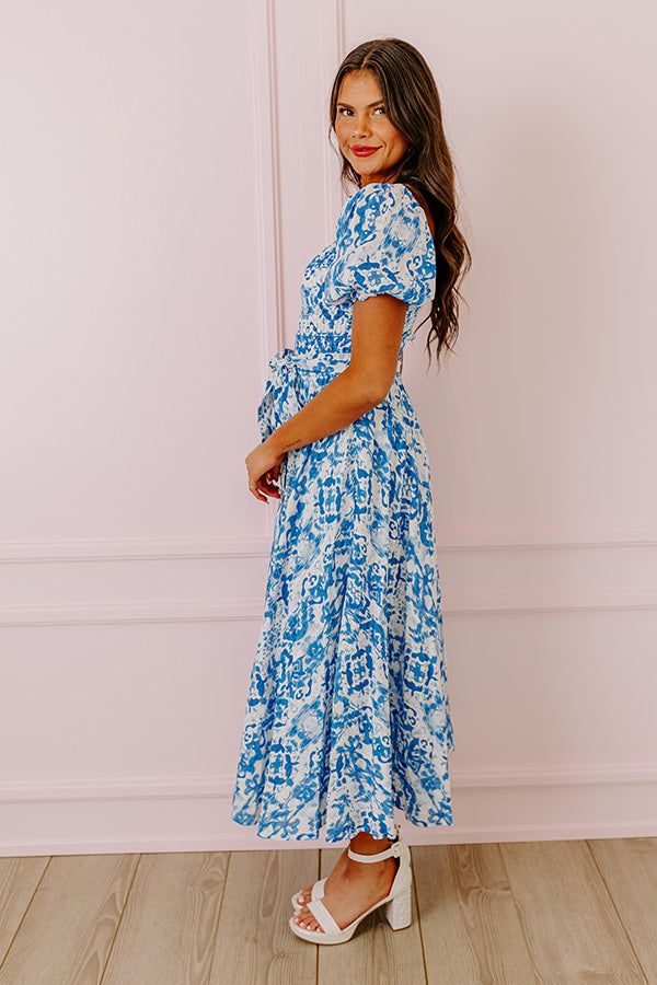 - Be a style inspiration with this sweet dress! - Material with a striped texture and a blue hued abstract print - A built-in skirt lining - An elastic scoop cut neckline - Short puff sleeves with elastic cuffs - A smocked bodice - A removable waist cinching tie closure belt - A relaxed silhouette that ends in a straight ankle length hemline Blue Maxi Dress With Smocked Back For Brunch, Blue Bohemian Midi Dress With Smocked Back, Blue Short Sleeve Maxi Dress With Smocked Back, Flowy Blue Midi Dress With Smocked Back, Blue Midi Dress With Smocked Back And Short Sleeves, Blue Short Sleeve Midi Dress With Smocked Back, Smocked Maxi Dress, Skirt Lining, Ocean Breeze