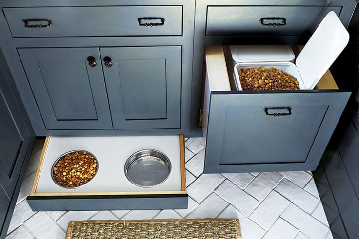 two bowls with food in them are sitting on the floor next to some cabinets and drawers