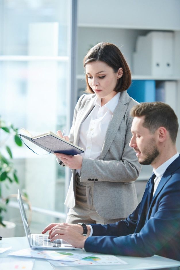 two business people working on laptops in an office stock photo 547982