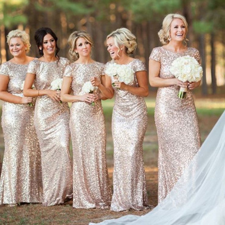 the bride and her bridesmaids are all dressed in gold sequin gowns