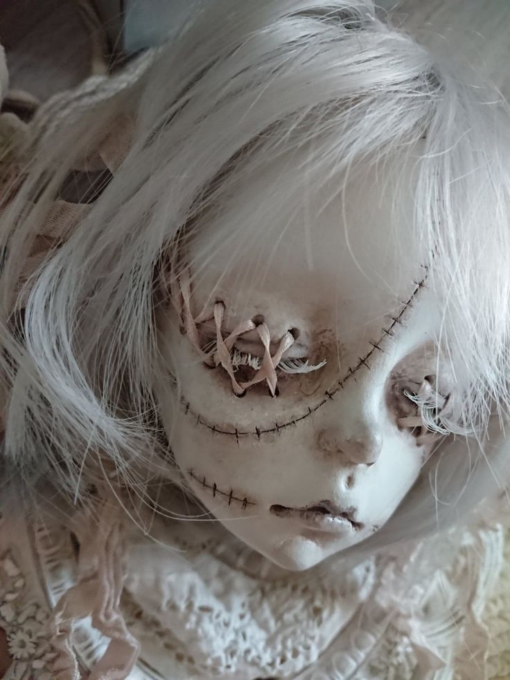 a doll with white hair and makeup on it's face is shown from above