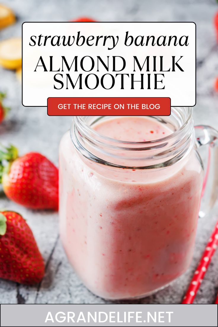 a strawberry banana almond milk smoothie in a mason jar with strawberries around it