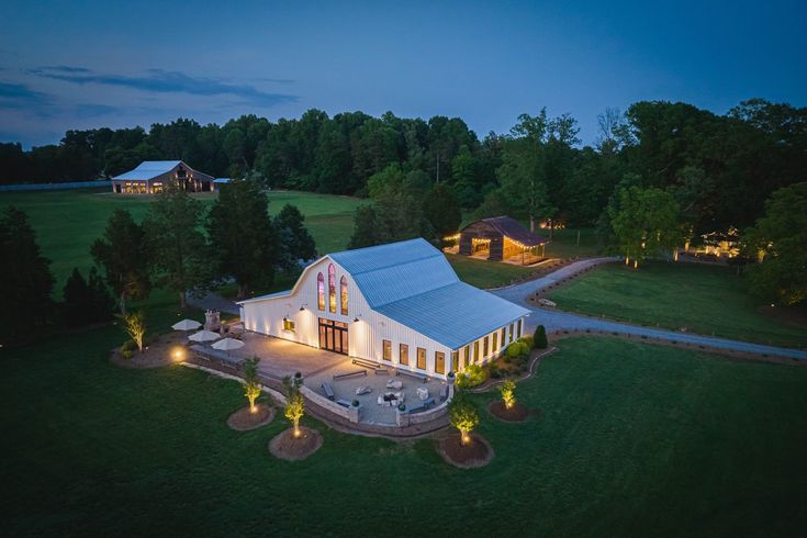 an aerial view of a large white house at night