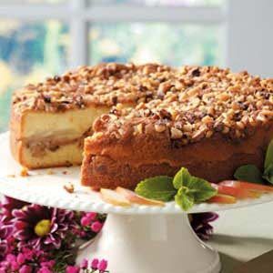 a cake that is sitting on top of a white plate with flowers in the background