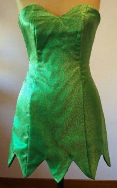 a green dress on a mannequin head stand