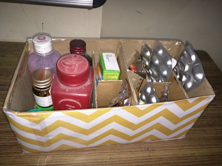 a box filled with lots of items on top of a wooden table