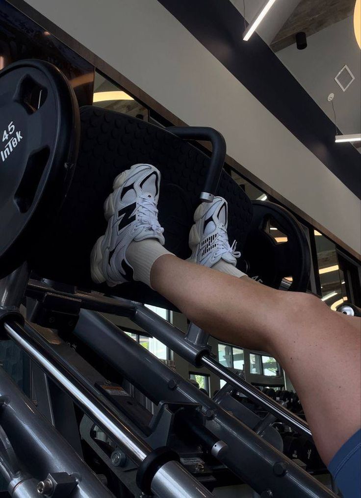 a person is standing on a machine with their feet up