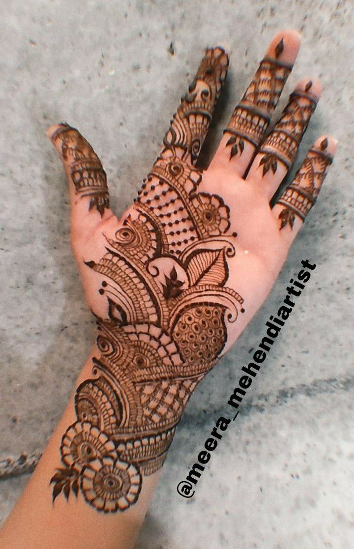 the hand is decorated with henna on it