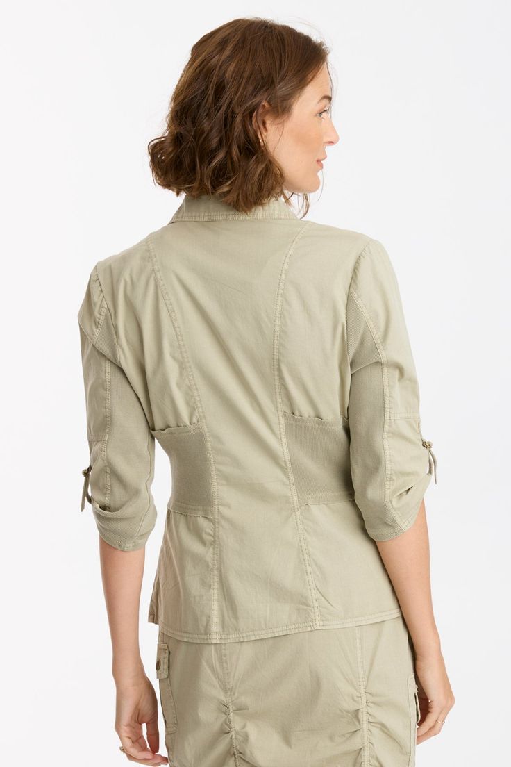 Made of our premium poplin, a classic collar graces this form-fitting jacket. Wexel features an antique brass ring pull zipper, twill tape details on the buckled cargo pockets and antique brass eyelet details throughout. Also featuring contrasting panels at the front/back waist and under the sleeve for maximum flexibility. Brio Poplin: 97/3 Cotton/Spandex. 2x1 Rib Waistband Contrast: 95/5 Cotton/Spandex. Center Front: ~21.25". Center Back: ~23". Color Description: Dusty spring green. Preshrunk. Fitted Cotton Utility Jacket With Flap Pockets, Fitted Utility Jacket With Flap Pockets And Collared Shape, Fitted Collared Utility Jacket With Flap Pockets, Classic Fitted Khaki Utility Jacket, Fitted Cotton Blazer With Flap Pockets, Fitted Cotton Utility Jacket With Button Closure, Fitted Cotton Utility Jacket For Workwear, Fitted Utility Jacket With Button Closure, Fitted Cotton Utility Blazer