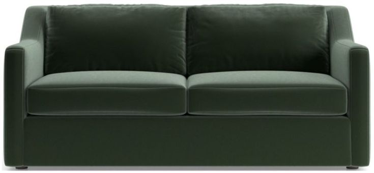 a green couch sitting on top of a white floor