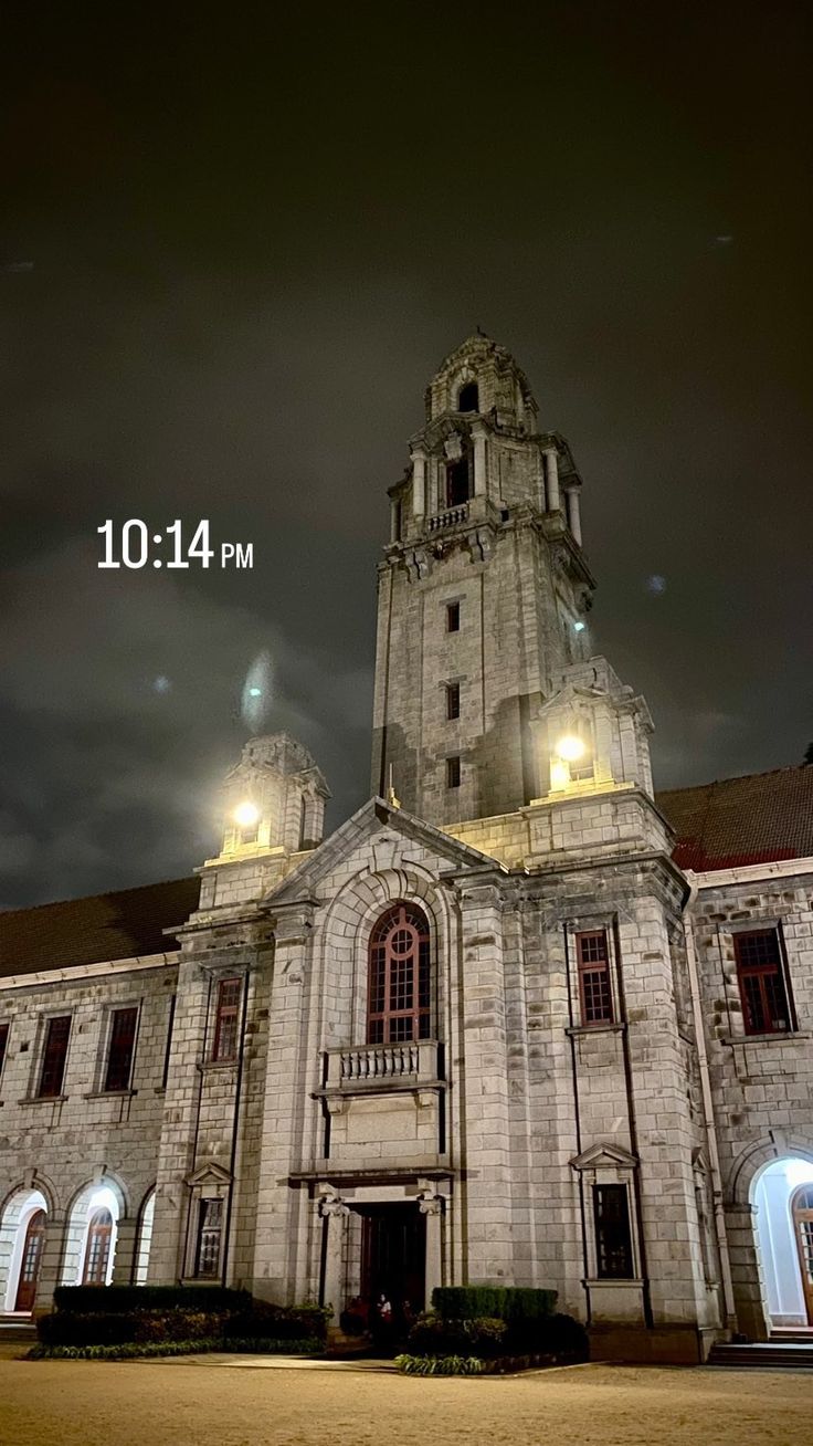 an old church lit up at night time