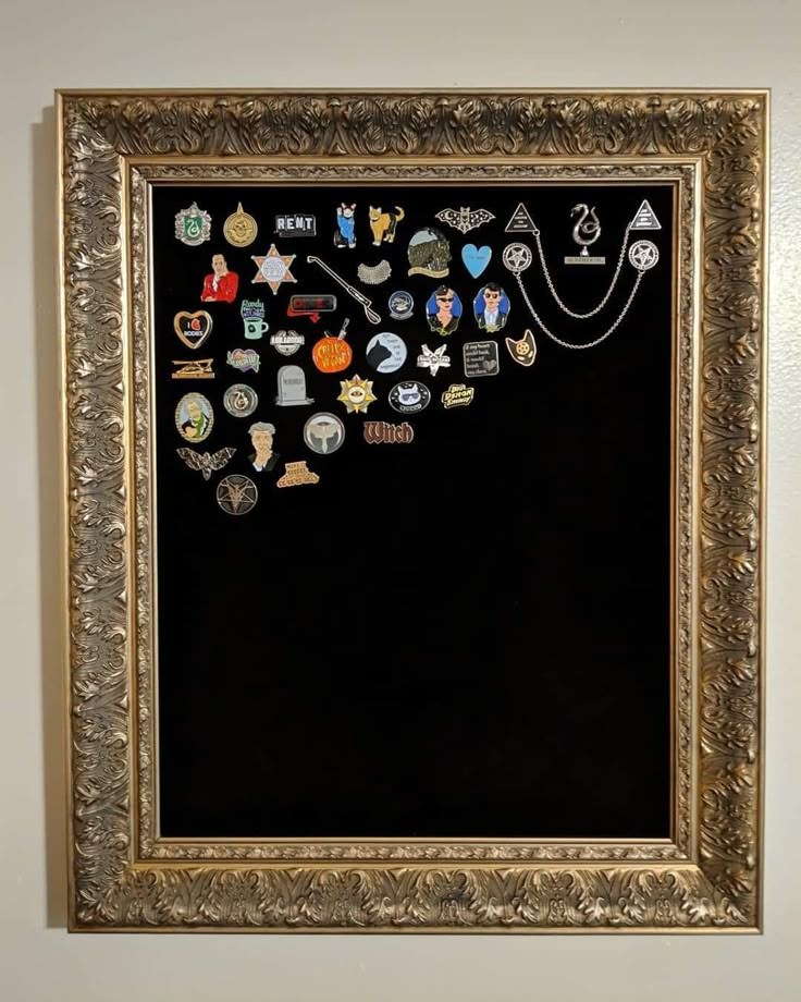 a blackboard with many different badges on it and a gold frame around the edges