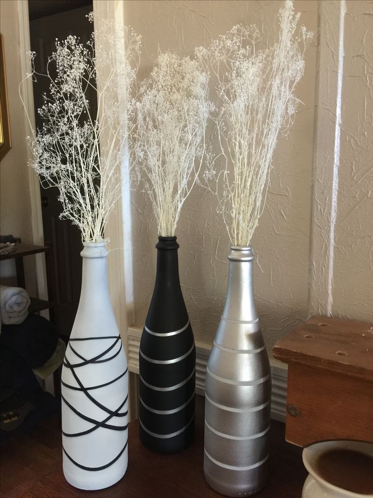 three vases sitting on top of a wooden table