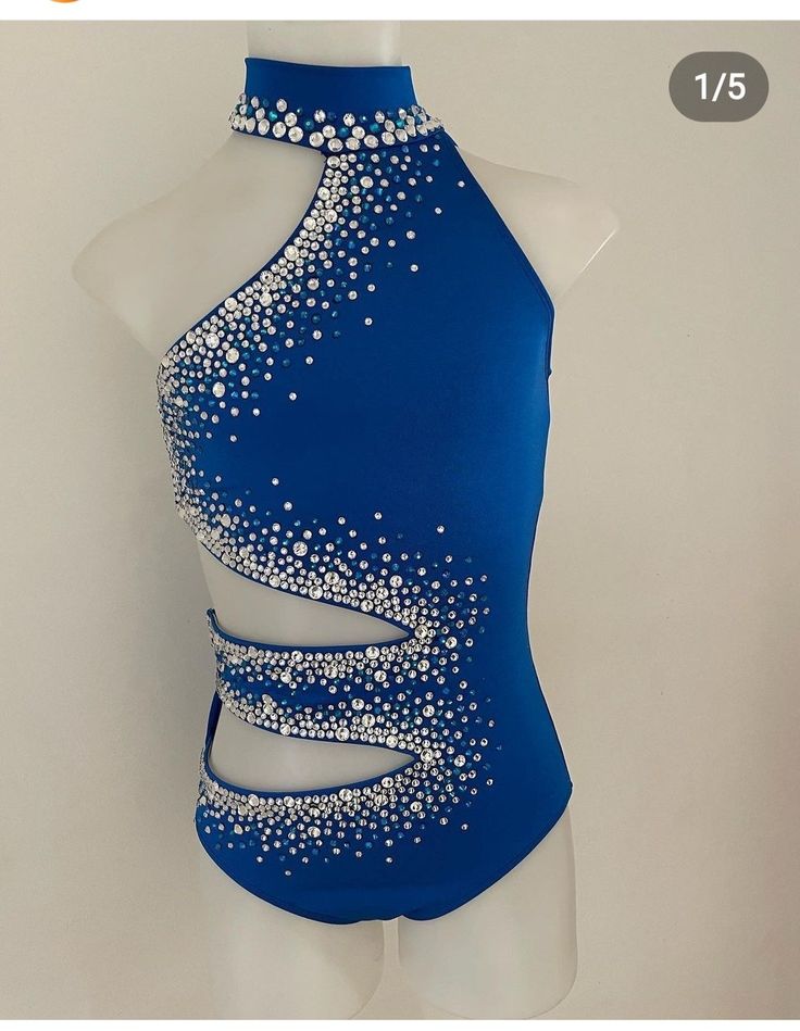 a woman's blue leotard with white beads on it