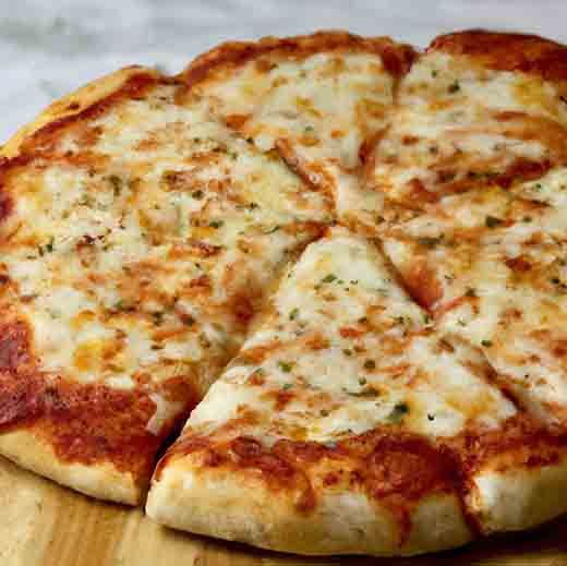 a cheese pizza on a wooden cutting board