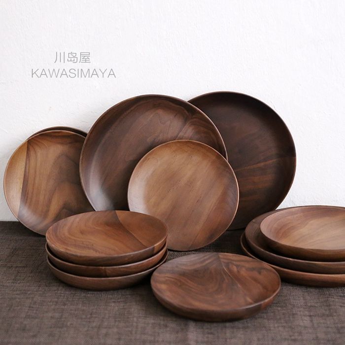 a pile of wooden plates sitting on top of a table