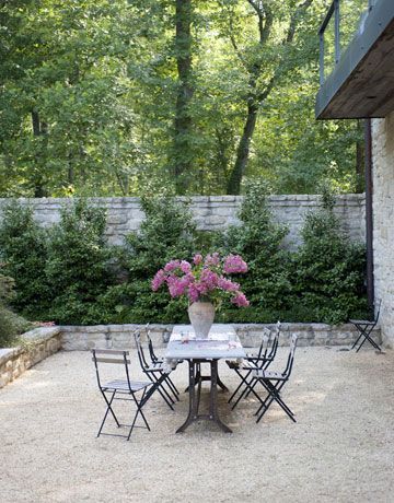 an instagram photo of a table and chairs with flowers in the vase on top