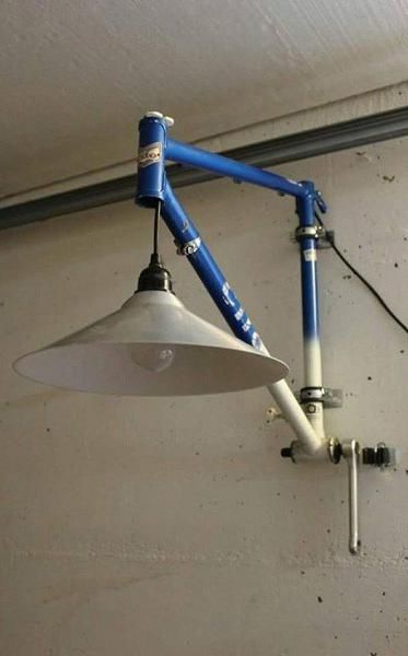 a blue and white lamp hanging from the side of a wall