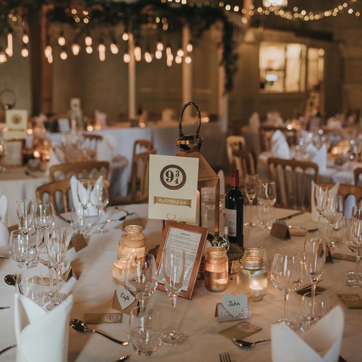 the table is set with wine glasses and place settings for guests to sit down at