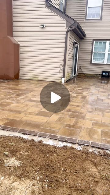 a patio being built in front of a house with a video screen showing how to install the pavers