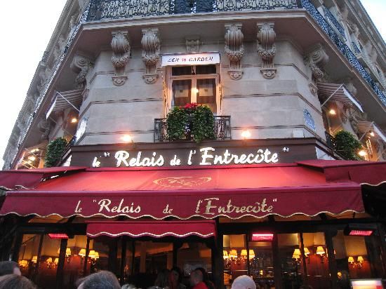 people are walking in front of a restaurant called redis d'entreette