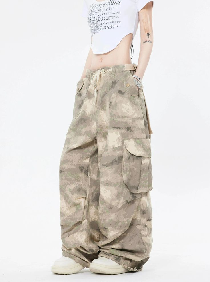 Embrace the street aesthetic with our Faded Baggy Camo Cargo Pants, perfect for making a statement while on the move.
Designed with a natural waist, these cargo pants offer a blend of comfort and durability. The camouflage pattern adds an edgy touch, while the drawstring and convenient pockets provide functionality and ease. The relaxed wide-leg silhouette ensures a nonchalant yet purposeful style, tailored for the contemporary wardrobe.
Pair them with a cropped hoodie and sneakers for running e Combat Style Baggy Wide Leg Bottoms, Baggy Wide Leg Combat Pants, Baggy Hip Hop Cargo Jeans For Outdoor, Hip Hop Style Baggy Cargo Jeans For Outdoor, Baggy Cargo Jeans Hip Hop Style, High Waist Khaki Cargo Pants For Streetwear, High Waist Combat Pants For Streetwear, Y2k Streetwear Pants With Multiple Pockets, Urban Style Full-length Summer Cargo Pants