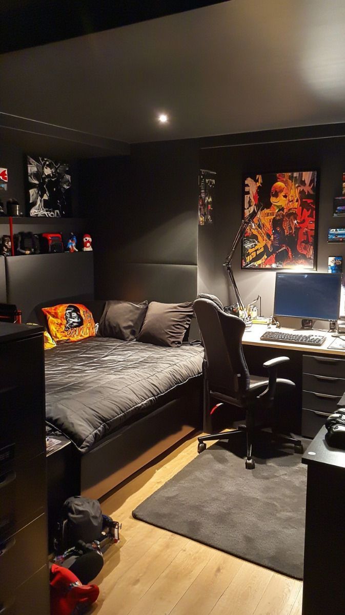 a bed room with a neatly made bed and a computer on top of the desk